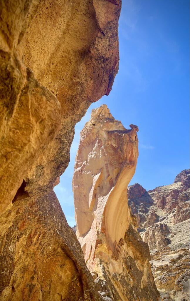 Silhouette of cliff around a tall rock