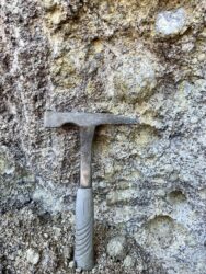 rock pick next to thunderegg still in the wall